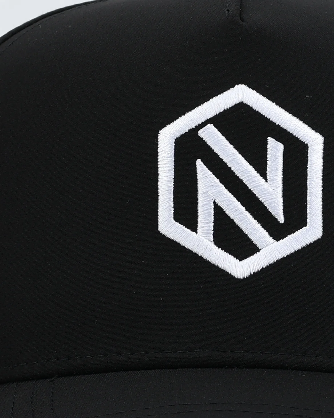 Macro of the white embroidered hex N on a black NOGNS cap