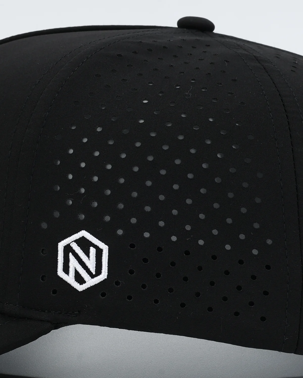 Laser-perforated side panel with the small embroidered hex N