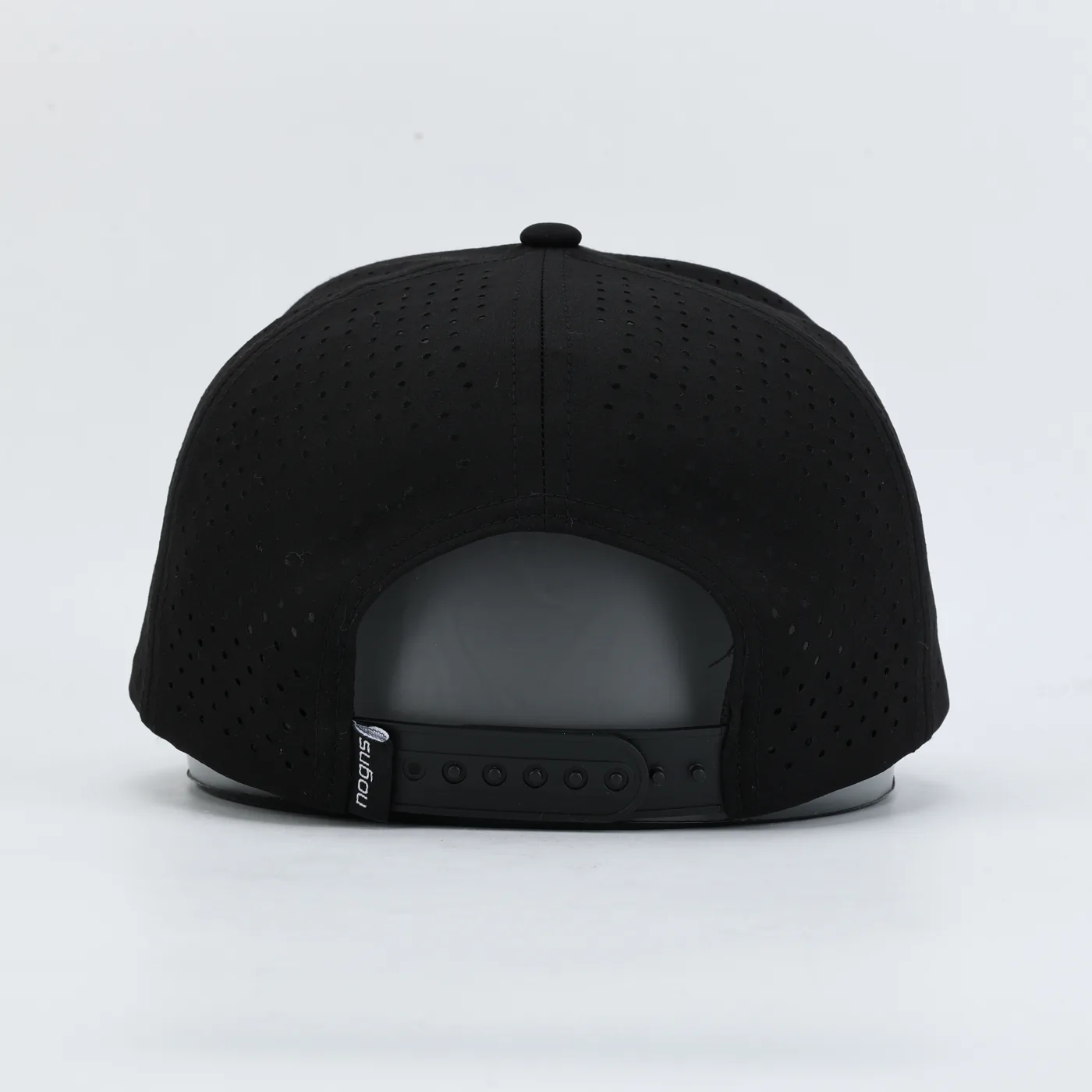The back of a black NOGNS cap: perforated panels and the adjustable snap closure